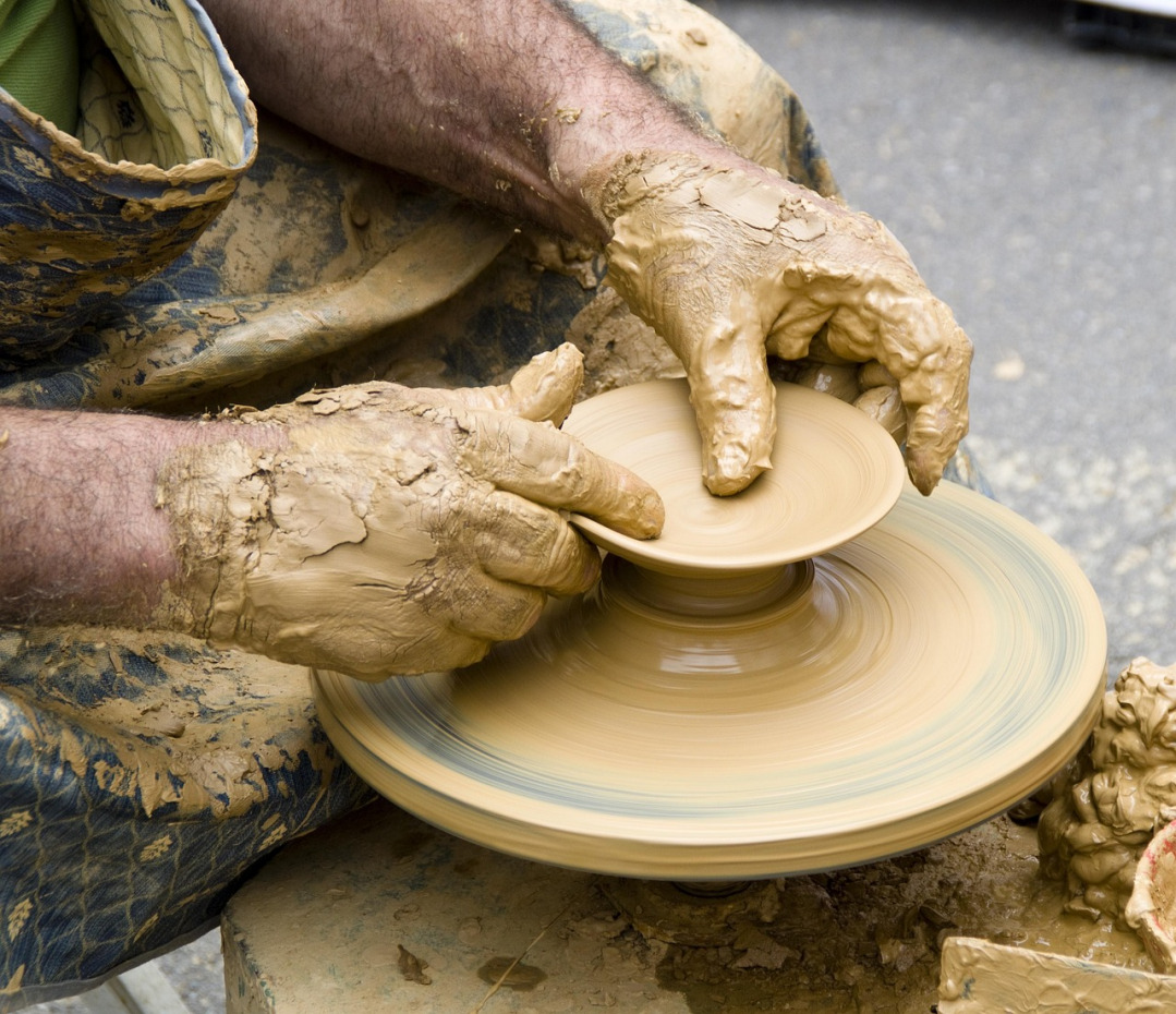 pottery wheel hands shaping clay